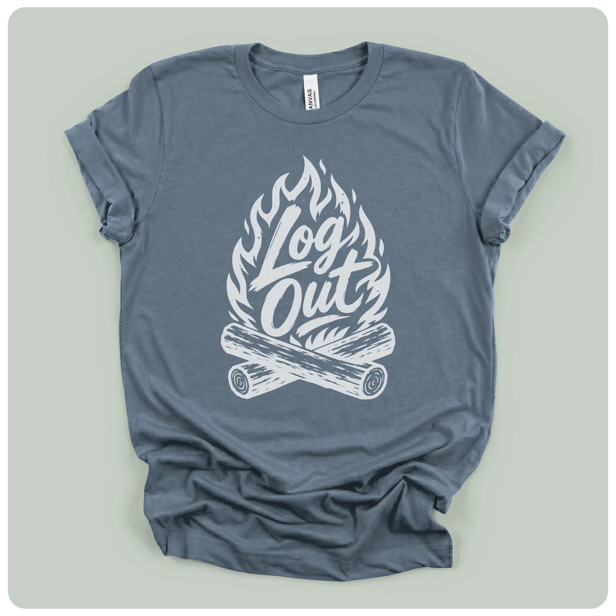 A slate blue crewneck t-shirt with a white graphic of a campfire and the text 'Log Out' in a stylized font, laid flat on a light gray background.