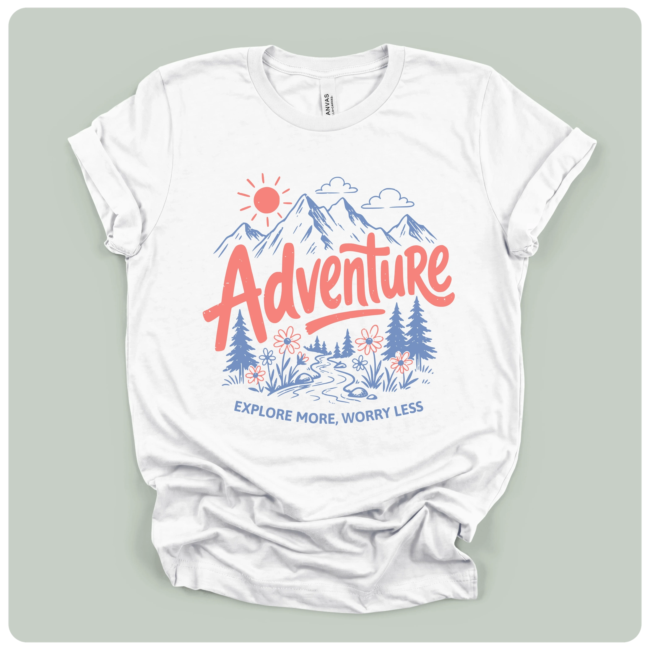 A white short-sleeve t-shirt with a colorful graphic print on the front. The graphic features a red sun, blue mountains, blue pine trees, and red and blue text reading 'Adventure' and 'EXPLORE MORE, WORRY LESS'.
